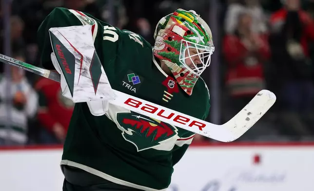Minnesota Wild goaltender Jesper Wallstedt (30) celebrates the team's win over the Ottawa Senators after an NHL hockey game Saturday, Dec. 13, 2025, in St. Paul, Minn. (AP Photo/Matt Krohn)