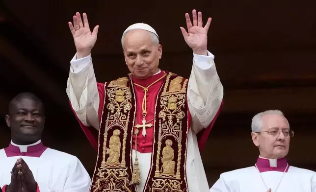 Pope Leo XIV waves after delivering the Urbi et Orbi (Latin for 'to the city and to the world' ) Christmas' day blessing from the main balcony of St. Peter's Basilica at the Vatican, Thursday, Dec. 25, 2025. (AP Photo/Gregorio Borgia)