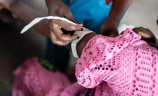 Irene Nabudeba, pregnant, mother of 5, waits for a consultation that used to be free at the Afia Himbi Hospital in Goma, Democratic Republic of Congo, Nov. 11, 2025. (AP Photo/Moses Sawasawa)