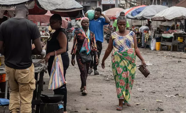 Ernestine Baleke walks to the Rehema Health Center to receive pre-natal care that used to be free at the Rehema Health Center in Goma, Democratic Republic of Congo, Nov. 14, 2025. (AP Photo/Moses Sawasawa)