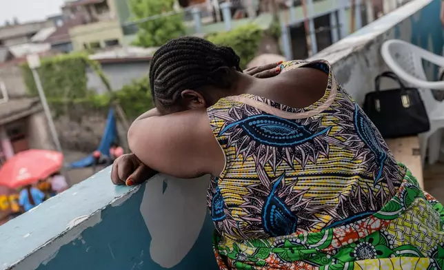 Ernestine Baleke rests on a wall after receiving pre-natal care that used to be free at the Rehema Health Center in Goma, Democratic Republic of Congo, Nov. 14, 2025. (AP Photo/Moses Sawasawa)