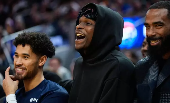 Minnesota Timberwolves guard Anthony Edwards, center, reacts from the bench during the second half of an NBA basketball game against the Golden State Warriors, Friday, Dec. 12, 2025, in San Francisco. (AP Photo/Godofredo A. Vásquez)