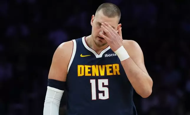 Denver Nuggets center Nikola Jokic (15) walks on the court during the first half of an NBA basketball game against the Miami Heat, Monday, Dec. 29, 2025, in Miami. (AP Photo/Lynne Sladky)