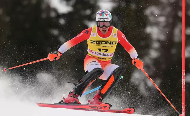 Switzerland's Daniel Yule speeds down the course during an alpine ski, men's World Cup slalom, in Alta Badia, Italy, Monday, Dec. 22, 2025. (AP Photo/Alessandro Trovati)