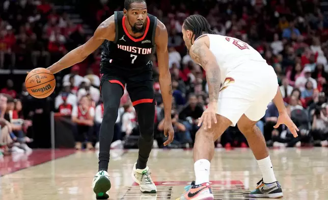 Houston Rockets forward Kevin Durant (7) dribbles as Cleveland Cavaliers guard Jaylon Tyson defends during the first half of an NBA basketball game, Saturday, Dec. 27, 2025, in Houston. (AP Photo/Eric Christian Smith)