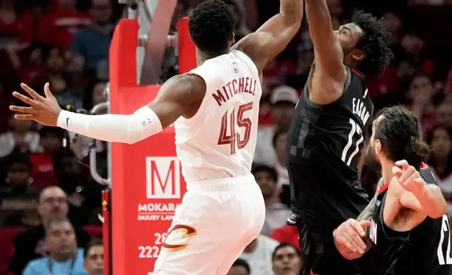 Houston Rockets forward Tari Eason (17) blocks the shot of Cleveland Cavaliers guard Donovan Mitchell (45) during the first half of an NBA basketball game, Saturday, Dec. 27, 2025, in Houston. (AP Photo/Eric Christian Smith)
