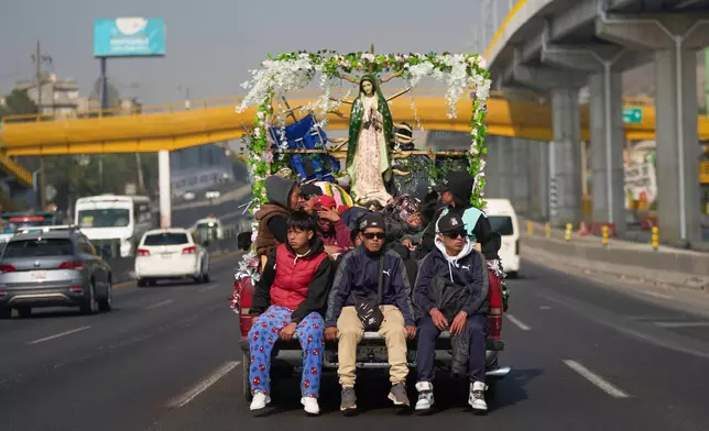 Pilgrims arrive from Puebla for the annual festivities honoring Our Lady of Guadalupe, in Mexico City, Wednesday, Dec. 10, 2025. (AP Photo/Claudia Rosel)