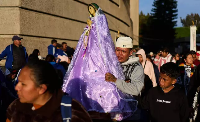 Pilgrims arrive to Our Lady of Guadalupe Basilica in Mexico City, Thursday, Dec. 11, 2025, the day before her feast day. (AP Photo/Claudia Rosel)