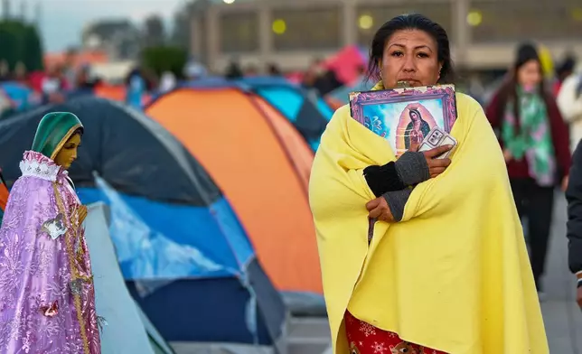 Pilgrims arrive to Our Lady of Guadalupe Basilica in Mexico City, Thursday, Dec. 11, 2025, the day before her feast day. (AP Photo/Claudia Rosel)