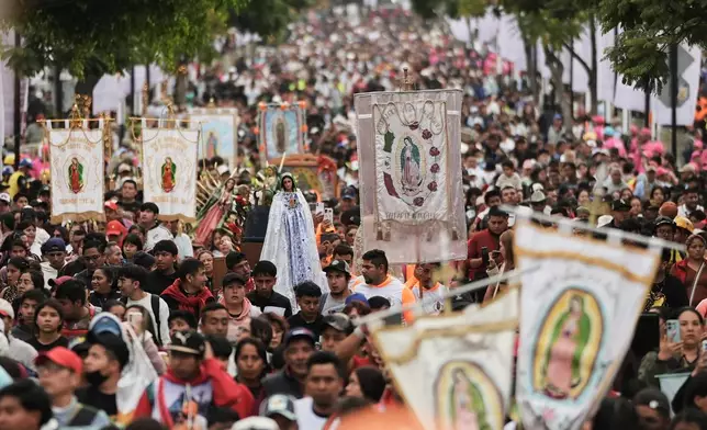 Pilgrims arrive at Our Lady of Guadalupe Basilica in Mexico City, Thursday, Dec. 11, 2025, the day before her feast day. (AP Photo/Claudia Rosel)