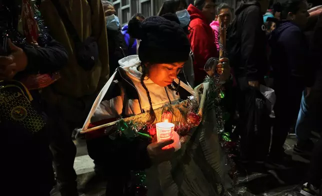 A woman prays inside the Basilica of Our Lady of Guadalupe in Mexico City, on her feast day, Friday, Dec. 12, 2025. (AP Photo/Claudia Rosel)