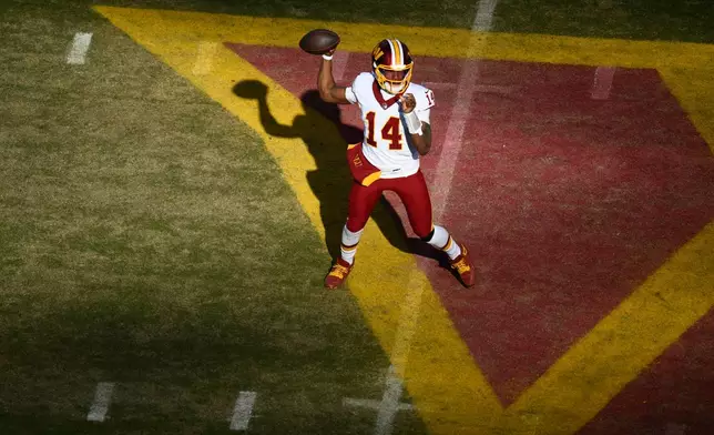 Washington Commanders quarterback Josh Johnson (14) throws during the first half an NFL football game against the Dallas Cowboys Thursday, Dec. 25, 2025, in Landover, Md. (AP Photo/Nick Wass)