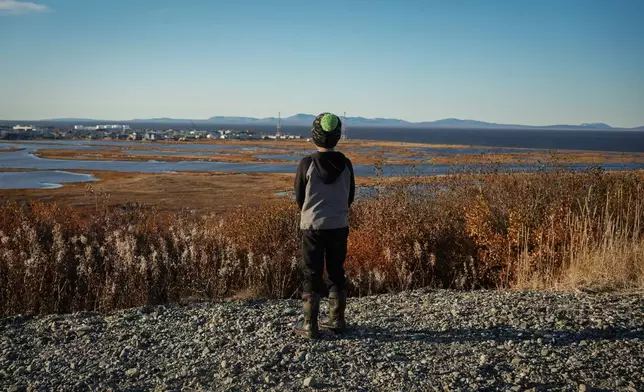James Schaeffer, 7, looks out at a view of Kotzebue, Alaska, Friday, Sept. 26, 2025. (AP Photo/Annika Hammerschlag)
