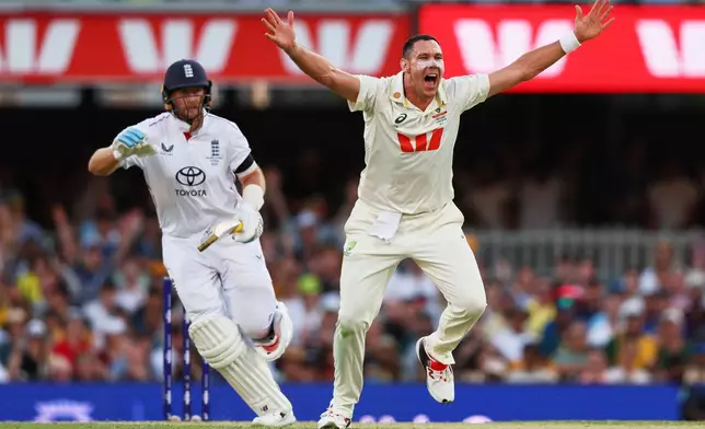 Australia's Scott Boland appeals unsuccessfully for the wicket of England's Harry Brook, unseen, during the second Ashes cricket test match between Australia and England in Brisbane, Thursday, Dec. 4, 2025.. (AP Photo/Tertius Pickard)