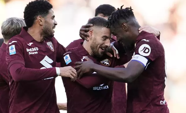 Torino's Nikola Vlasic, center, celebrates scoring during the Italian Serie A soccer match between Torino and Cremonese in Turin, Italy, Saturday, Dec. 13, 2025. (Fabio Ferrari/LaPresse via AP)