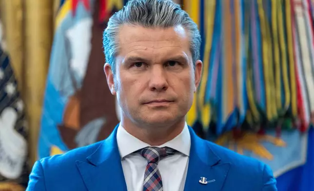 Defense Secretary Pete Hegseth listens as President Donald Trump speaks during a Mexican Border Defense Medal presentation in the Oval Office of the White House, Monday, Dec. 15, 2025, in Washington. (AP Photo/Alex Brandon)