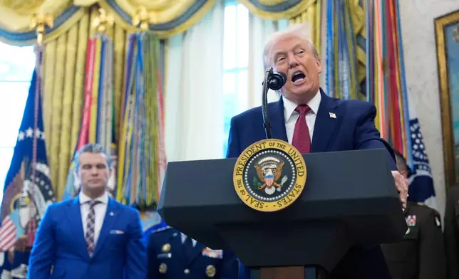 President Donald Trump speaks during a Mexican Border Defense Medal presentation in the Oval Office of the White House, Monday, Dec. 15, 2025, in Washington, as Defense Secretary Pete Hegseth, looks on. (AP Photo/Alex Brandon)