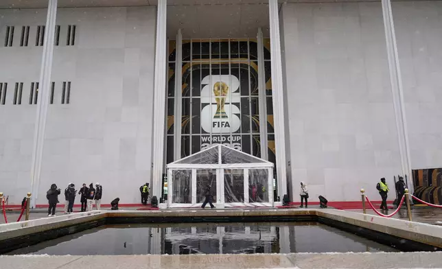 People arrive for the draw for the 2026 soccer World Cup at the Kennedy Center in Washington, Friday, Dec. 5, 2025. (AP Photo/Stephanie Scarbrough)