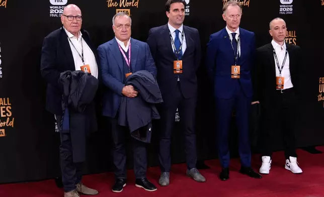 Curacao's coach Dick Advocaat, 2nd left, arrives to attend the draw for the 2026 soccer World Cup at the Kennedy Center in Washington, Friday, Dec. 5, 2025. (AP Photo/Julia Demaree Nikhinson)