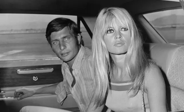 FILE - French film actress Brigitte Bardot and her husband Gunter Sachs pose just before boarding a chartered airplane on their honeymoon in Las Vegas on July 14, 1966. (AP Photo/David F. Smith, File)