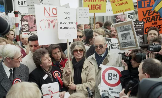 FILE - French actress Brigitte Bardot, center is surrounded by animal rights protestors during a demonstration against transporting live animals in Brussels, Monday, Feb. 20, 1995. (AP Photo/Jacques Collet, File)