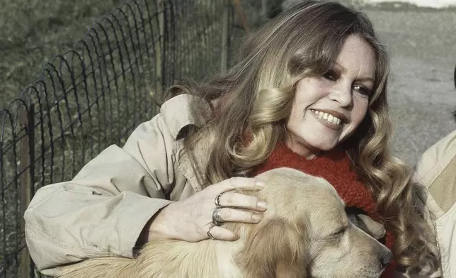 FILE - French Actress Brigitte Bardot with a dog in the Gennevilliers, Paris, while supporting the French animal protection society operation, Feb. 10, 1982. (AP Photo/Duclos, File)