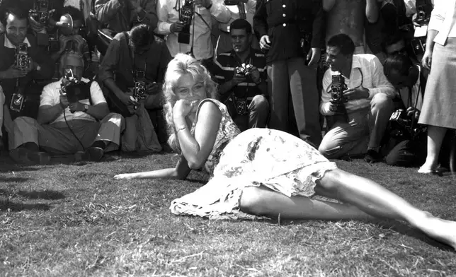 FILE - French actress Brigitte Bardot poses for photographers on a lawn in the garden of the Excelsior Hotel on the Lido of Venice, Italy, Sept. 2, 1958. (AP Photo/Walter Attenni, File)