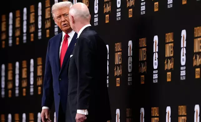 President Donald Trump speaks with FIFA President Gianni Infantino as they leave after the draw for the 2026 soccer World Cup at the Kennedy Center in Washington, Friday, Dec. 5, 2025. (AP Photo/Julia Demaree Nikhinson)