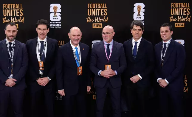 Spain's national team coach Luis de la Fuente, 3rd right, arrives to attend the draw for the 2026 soccer World Cup at the Kennedy Center in Washington, Friday, Dec. 5, 2025. (AP Photo/Julia Demaree Nikhinson)