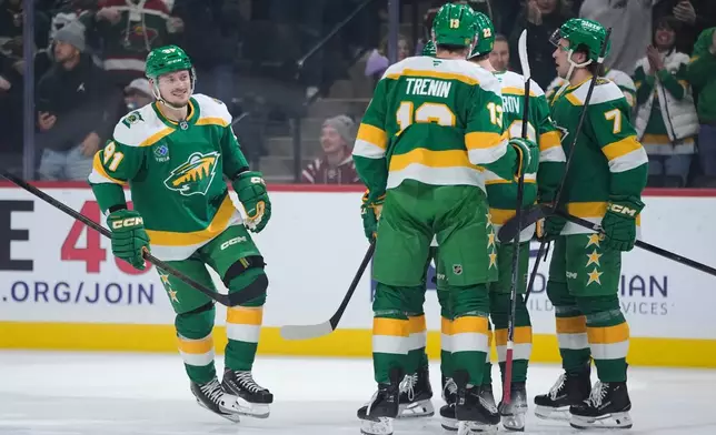 Minnesota Wild right wing Vladimir Tarasenko (91), left, celebrates after scoring a goal during the first period of an NHL hockey game against the Washington Capitals, Tuesday, Dec. 16, 2025, in St. Paul, Minn. (AP Photo/Abbie Parr)