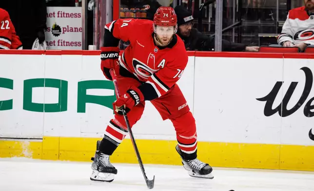 Carolina Hurricanes' Jaccob Slavin watches the puck during the second period of an NHL hockey game against the Philadelphia Flyers in Raleigh, N.C., Sunday, Dec. 14, 2025. (AP Photo/Ben McKeown)