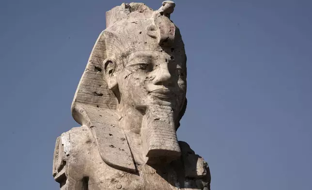 One of the two giant alabaster statues of Pharoah Amenhotep III, is photographed during the official opening, in the southern city of Luxor, Egypt, Sunday, Dec. 14, 2025. (AP Photo/Amr Nabil)