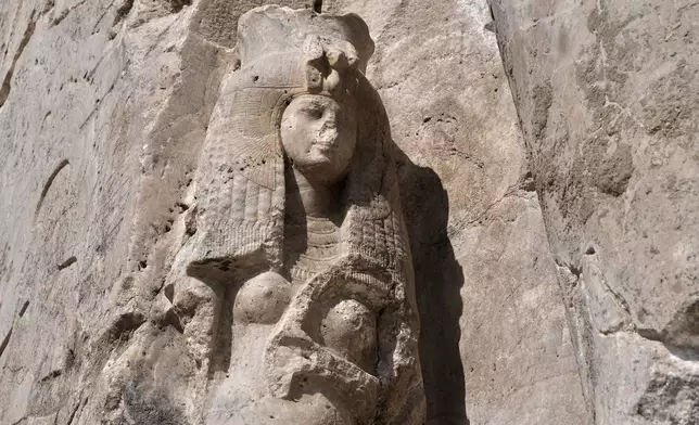 A view of the great royal Consort Tiye, near the right leg of the giant alabaster statue of Pharoah Amenhotep III, in the southern city of Luxor, Egypt, Sunday, Dec. 14, 2025. (AP Photo/Amr Nabil)
