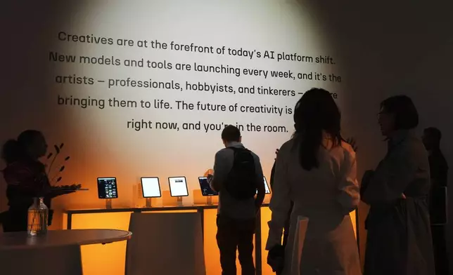 People gather at the a16z AI Creative Gallery, Thursday, Sept. 18, 2025, in New York. (AP Photo/Frank Franklin II)