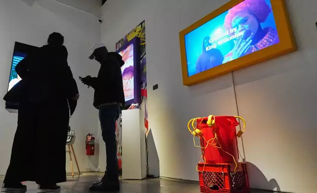 Willonius Hatcher, also known as King Willonius, talks to people during the a16z AI Creative Gallery, Thursday, Sept. 18, 2025, in New York. (AP Photo/Frank Franklin II)