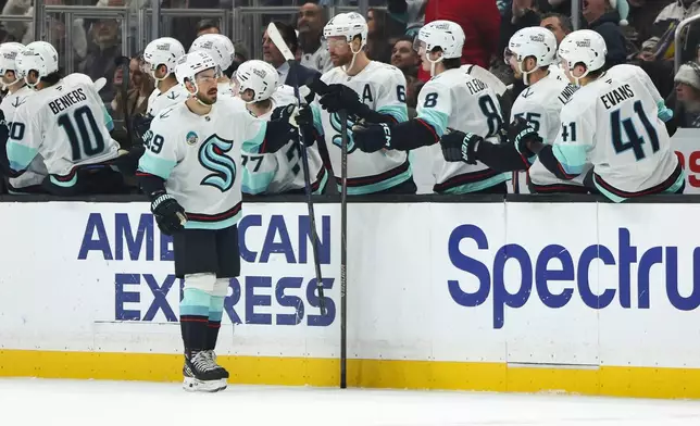 Seattle Kraken center Frederick Gaudreau (89) celebrates with his teammates after scoring a goal during the second period of an NHL hockey game against the Los Angeles Kings, Tuesday, Dec. 23, 2025, in Los Angeles. (AP Photo/Jessie Alcheh)