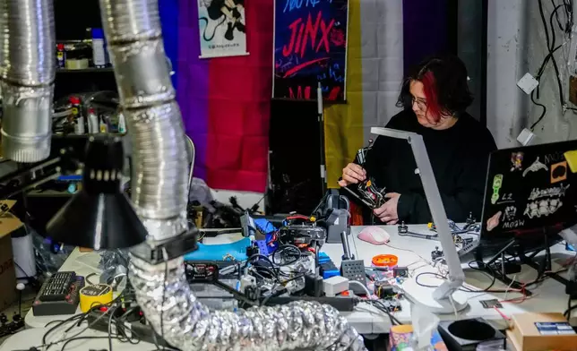 Chibi, a Ukrainian soldier from the Khartia brigade, tests a drone, Friday, Nov. 7, 2025, in Kharkiv Oblast, Ukraine. (AP Photo/Julia Demaree Nikhinson)