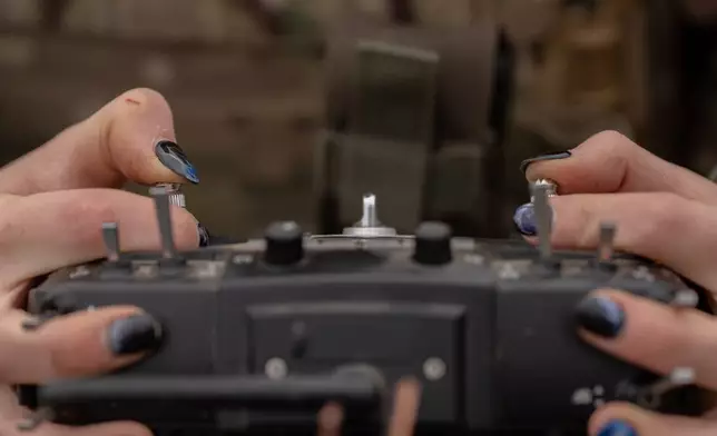 Monka, a Ukrainian FPV drone operator from the third assault brigade, pilots an FPV drone during a demonstration for The Associated Press, Wednesday, Nov. 5, 2025, in Kharkiv Oblast, Ukraine. (AP Photo/Julia Demaree Nikhinson)