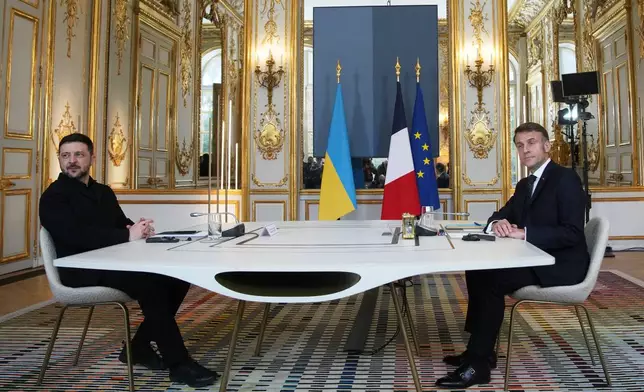 French President Emmanuel Macron, right, and Ukrainian President Volodymyr Zelenskyy pose prior to a meeting, Monday, Dec. 1, 2025, at the Elysee Palace in Paris. (AP Photo/Christophe Ena, Pool)