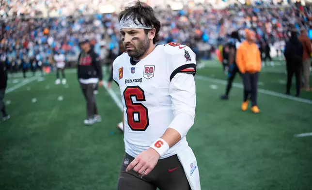 Tampa Bay Buccaneers quarterback Baker Mayfield leaves the field after their loss in an NFL football game between the Carolina Panthers and the Tampa Bay Buccaneers, Sunday, Dec. 21, 2025, in Charlotte, N.C. (AP Photo/Jacob Kupferman)