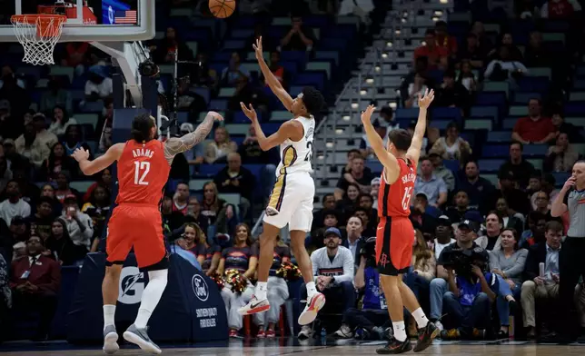 New Orleans Pelicans forward Trey Murphy III, center, shoots against Houston Rockets center Steven Adams (12) during the first half of an NBA basketball game in New Orleans, Thursday, Dec. 18, 2025. (AP Photo/Matthew Hinton)