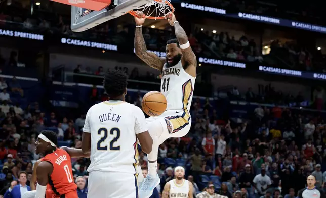 New Orleans Pelicans guard Saddiq Bey (41) dunks against Houston Rockets guard Aaron Holiday (0) near Pelicans center Derik Queen (22) during the second half of an NBA basketball game in New Orleans, Thursday, Dec. 18, 2025. (AP Photo/Matthew Hinton)
