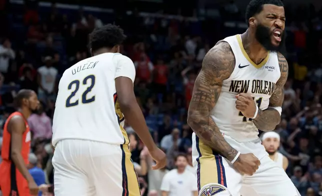 New Orleans Pelicans guard Saddiq Bey, right, reacts after dunking against the Houston Rockets during the second half of an NBA basketball game in New Orleans, Thursday, Dec. 18, 2025. (AP Photo/Matthew Hinton)