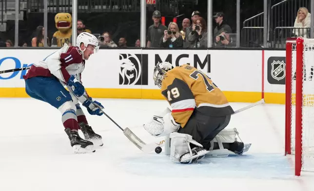 Vegas Golden Knights goaltender Carter Hart (79) stops a shot by Colorado Avalanche center Brock Nelson (11) during the first period of an NHL hockey game Saturday, Dec. 27, 2025, in Las Vegas. (AP Photo/Candice Ward)
