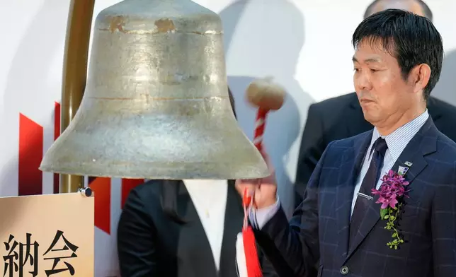 Hajime Moriyasu, the head coach of Japanese national soccer team, rings the bell during a ceremony to mark the last trading day of the year on the Tokyo Stock Exchange Tuesday, Dec. 30, 2025, in Tokyo. (AP Photo/Eugene Hoshiko)