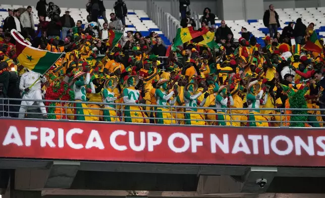Senegal supportes cheer during the Africa Cup of Nations group D soccer match between Benin and Senegal in Tangier, Morocco, Tuesday, Dec. 30, 2025. (AP Photo/Themba Hadebe)