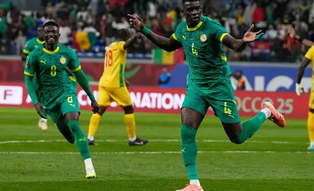 Senegal's Abdoulaye Seck, right, celebrate his goal with his teammates during the Africa Cup of Nations group D soccer match between Benin and Senegal in Tangier, Morocco, Tuesday, Dec. 30, 2025. (AP Photo/Themba Hadebe)