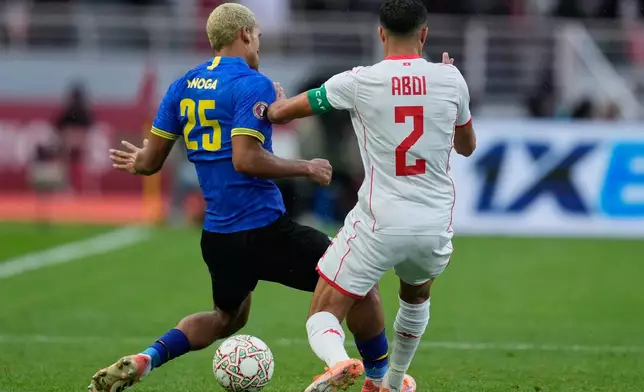 Tanzania's Haji Mnoga, left, and Tunisia's Ali Abdi compete for the ball during the Africa Cup of Nations group C soccer match between Tanzania and Tunisia in Rabat, Morocco, Tuesday, Dec. 30, 2025. (AP Photo/Mosa'ab Elshamy)