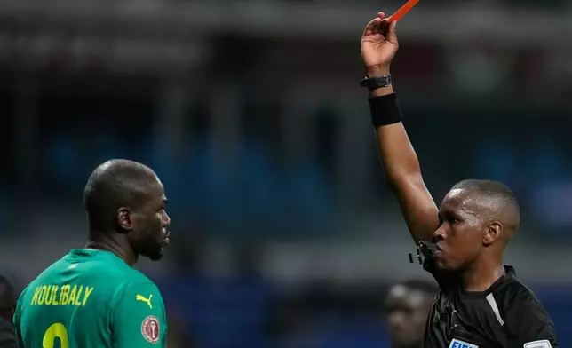 Senegal's Kalidou Koulibaly is shown a red card during the Africa Cup of Nations group D soccer match between Benin and Senegal in Tangier, Morocco, Tuesday, Dec. 30, 2025. (AP Photo/Themba Hadebe)