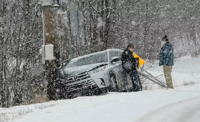 A single-vehicle crash on Route 9 in Marlboro, Vt., Tuesday, Dec. 2, 2025, occurred as a snowstorm passed through the region and the vehicle slid off the road and hit a utility pole. (Kristopher Radder/The Brattleboro Reformer via AP)